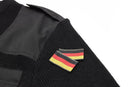 Close-up of black Mil-Tec German Bundeswehr wool sweater with shoulder epaulet and German flag patch