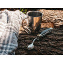 BOKER Bon Appetite pocket cutlery set with wooden handle and 440A steel spoon next to metal camping mug on wood.