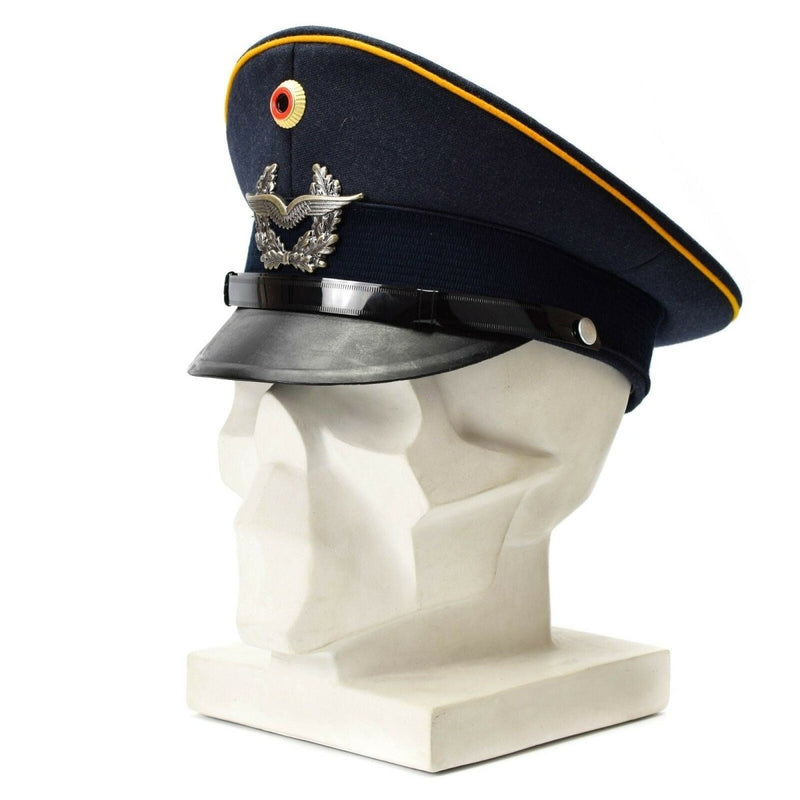 Vintage genuine German Luftwaffe Air Forces visor cap with military insignia and leather brim displayed on mannequin head.