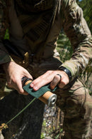 Person in camouflage cleaning Katadyn Pocket water filter during outdoor tactical or camping activity