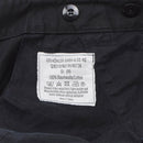 Close-up of black Leo Köhler military bermuda shorts label showing size medium and care instructions.