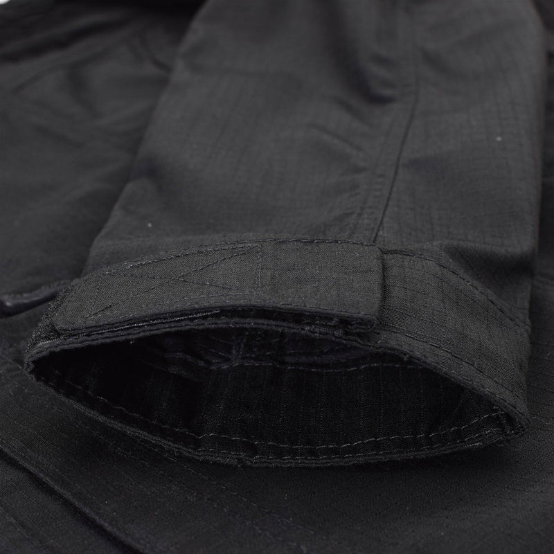 Close-up of black Mil-Tec ripstop fabric jacket cuff with adjustable strap and narrow fit design detail.