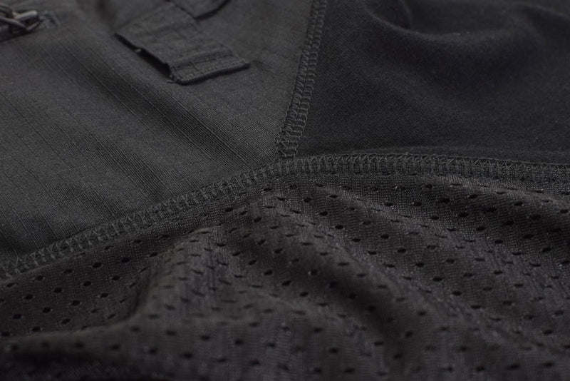 Close-up of black Mil-Tec tactical combat shirt fabric showing mesh ventilation and reinforced stitching details.