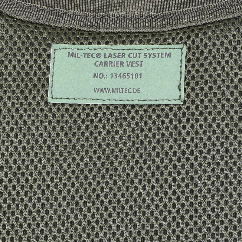 Close-up of olive mesh fabric with MIL-TEC laser cut system carrier vest label and product number.