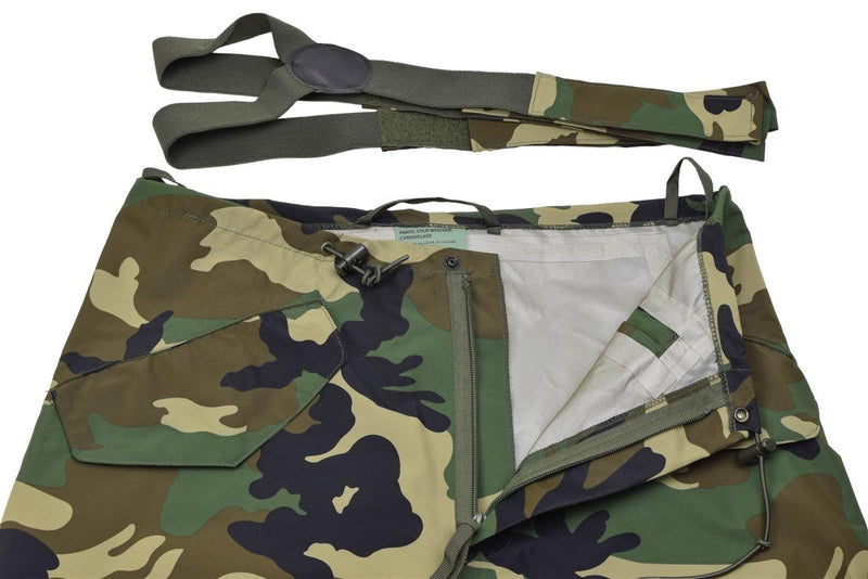 Close-up of MIL-TEC camouflage waterproof military pants with detachable braces and multiple pockets.