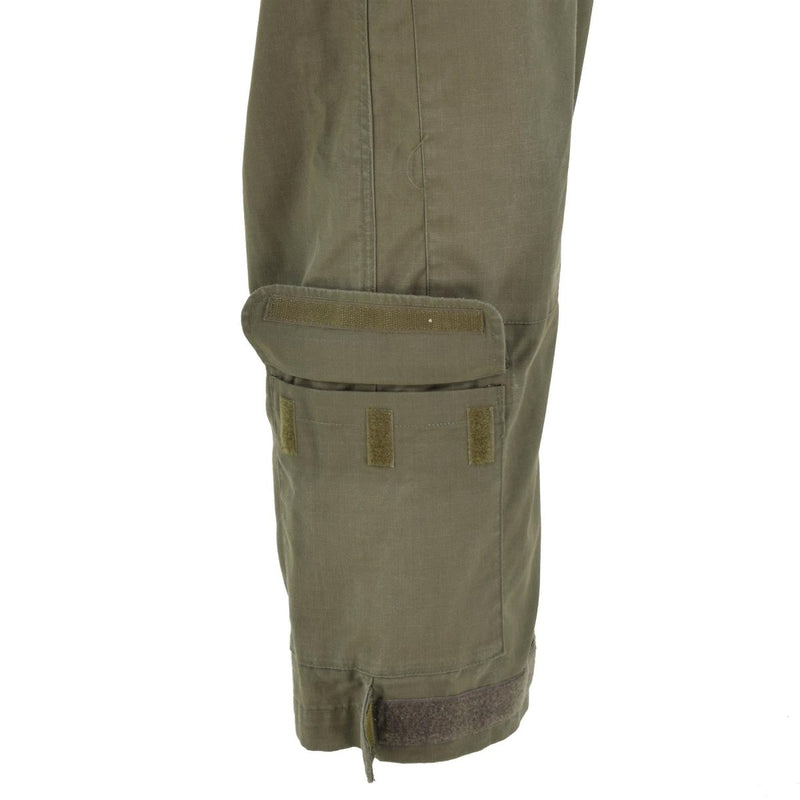 Close-up of olive green ripstop Austrian army coverall leg with adjustable hook and loop cuff and pocket flap details.