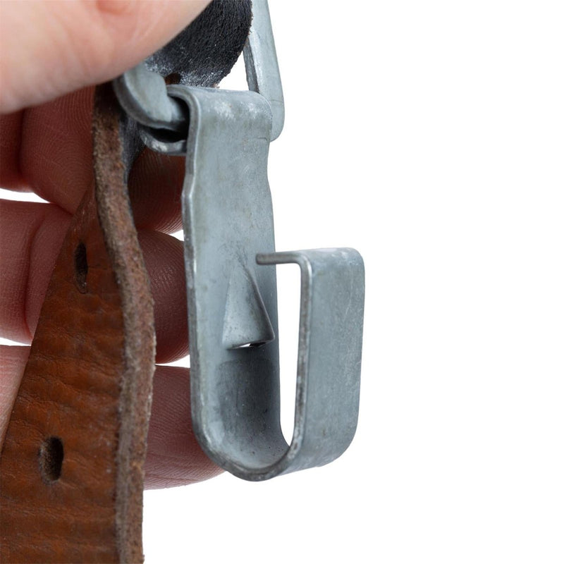 Close-up of metal clip attached to brown leather strap from original Austrian Army Y-Strap braces vintage military surplus