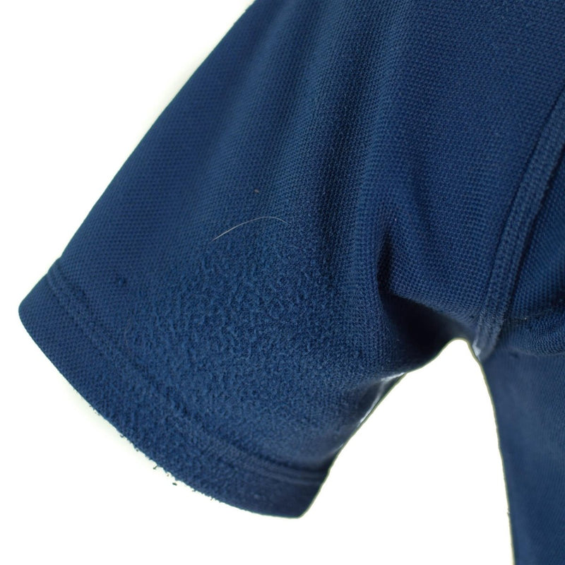 Close-up of breathable blue fabric and stitching on the sleeve of an original British police t-shirt.