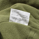 Close-up of olive green fleece fabric with a white care label showing polyester material and washing instructions.