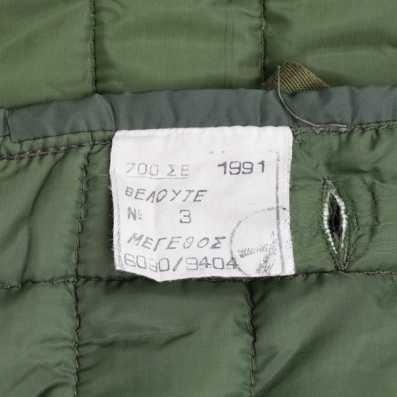 Close-up of label inside original Greek Army M65 quilted liner jacket dated 1991 in green fabric lining
