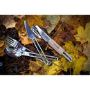 Lightweight stainless steel camping cutlery set with knife, fork, spoon, and leather sleeve on autumn leaves background.