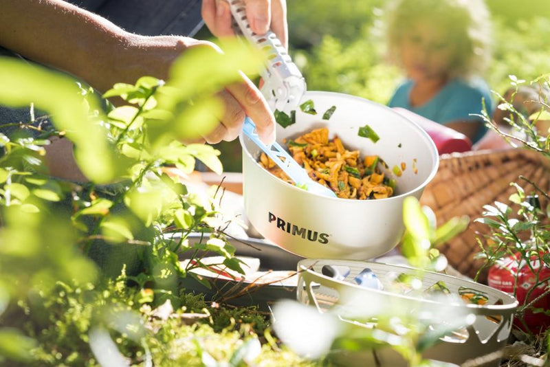 Primus Essential Stove Set 2.3L pot with cooked meal being served outdoors during camping trip
