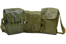 Three vintage olive green military surplus gas mask bags with shoulder straps isolated on white