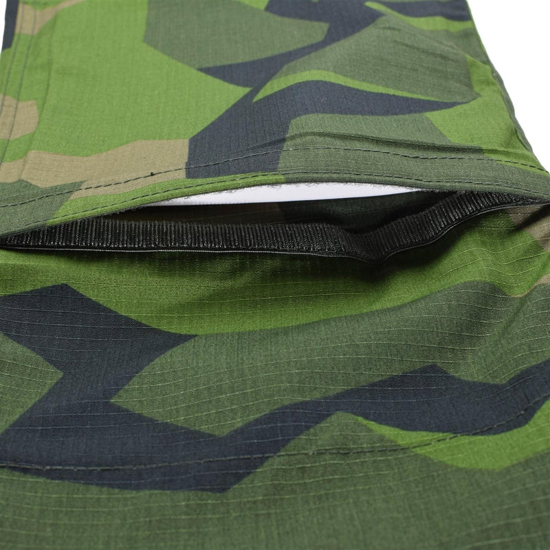 Close-up of TACGEAR Swedish Military style combat pants in Splinter camo showing ripstop fabric and leg pocket detail.